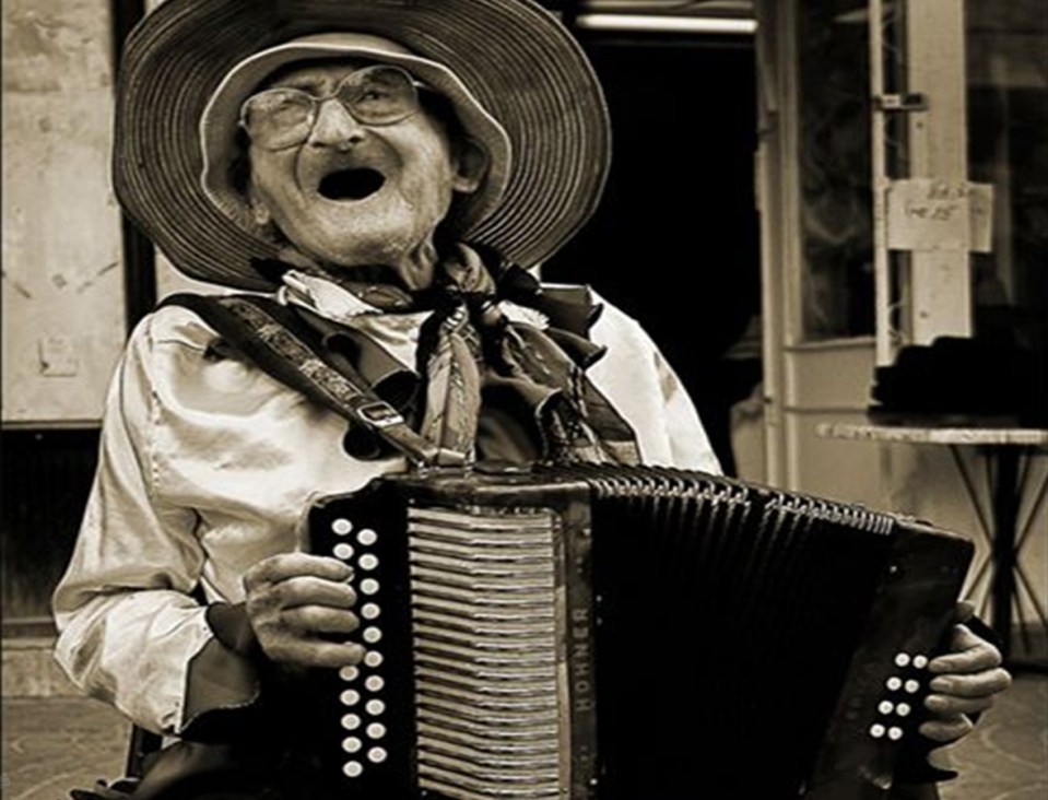 a grandmother plays the accordian